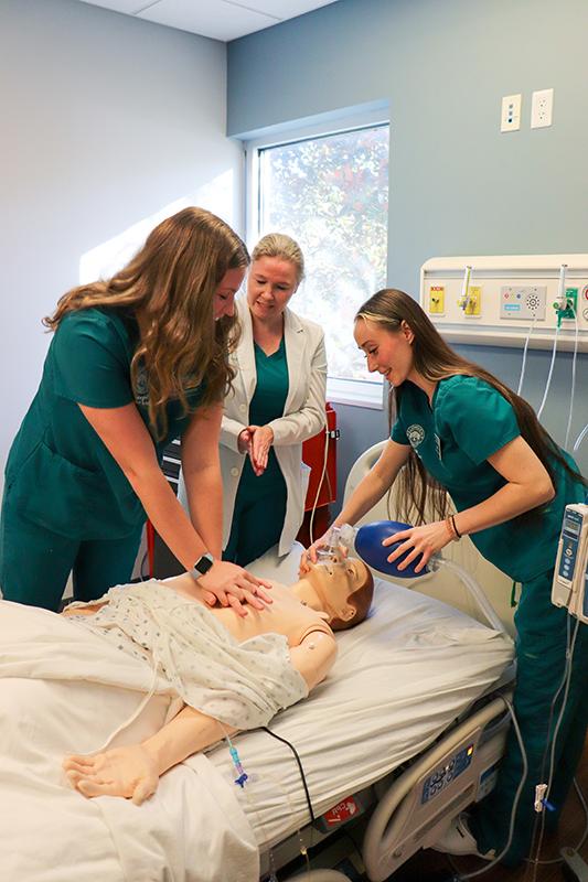 Nursing students perform CPR to a medical maniken